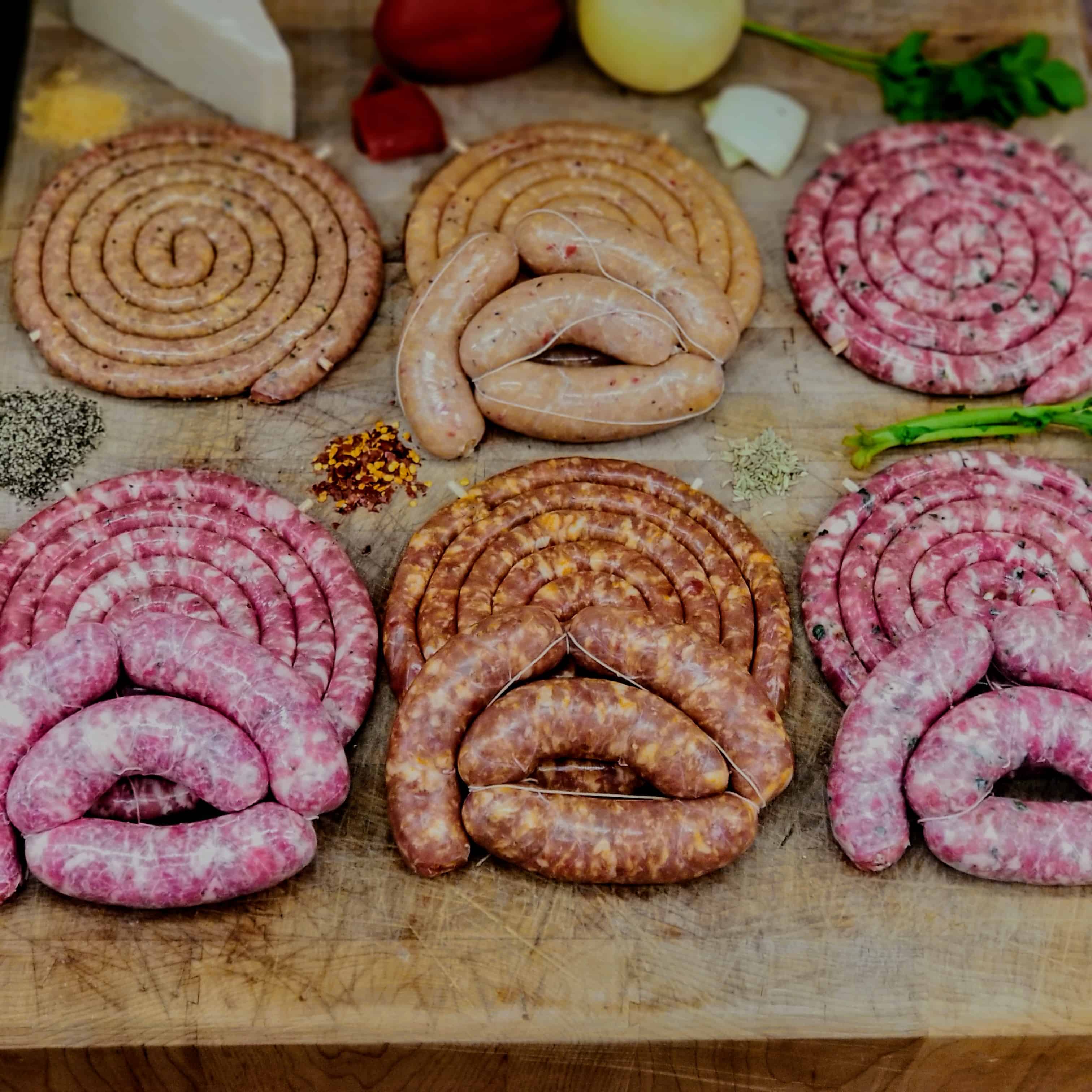 variety of butcher sausage links and sauage rolls